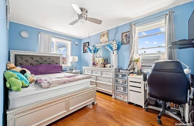 bedroom with light hardwood / wood-style floors, ceiling fan, and ornamental molding