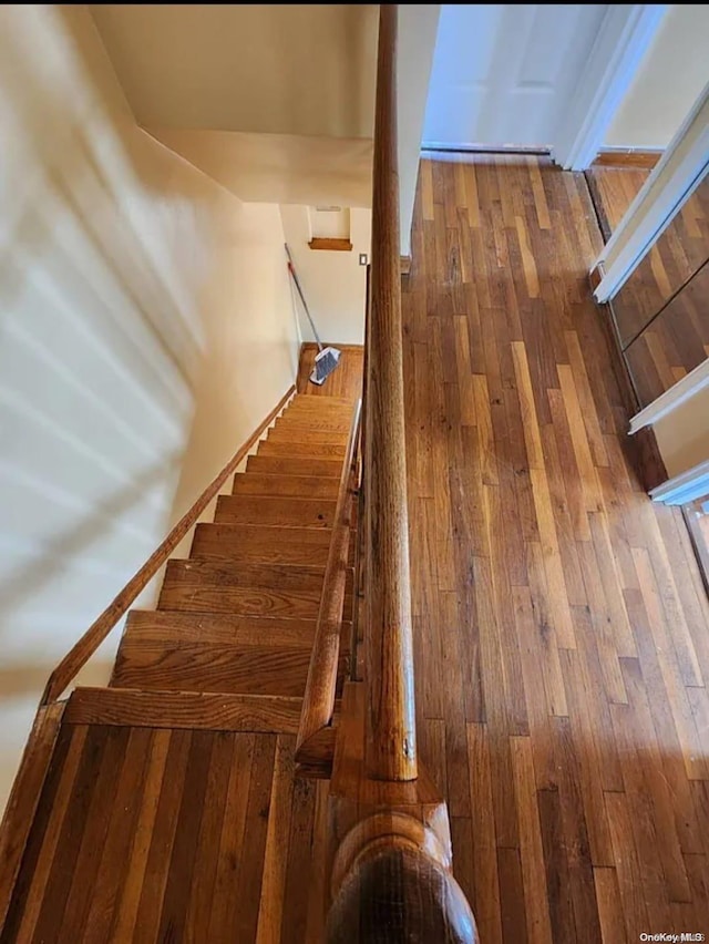 stairs with hardwood / wood-style floors