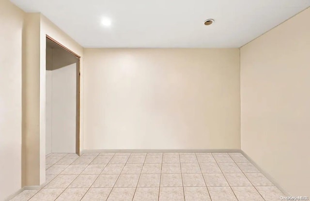 spare room with light tile patterned floors