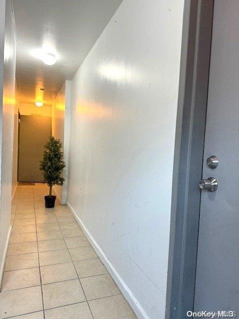 corridor with light tile patterned floors