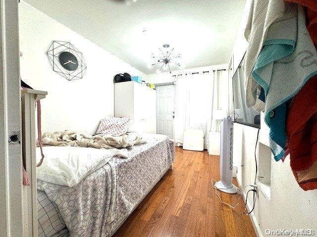 bedroom with wood-type flooring