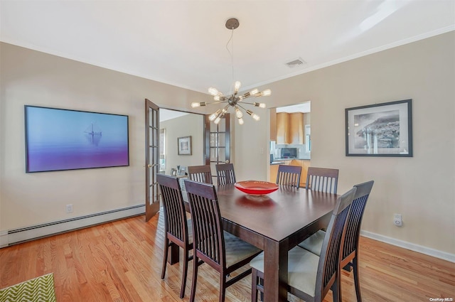 dining space featuring french doors, an inviting chandelier, ornamental molding, light wood-type flooring, and baseboard heating