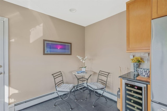 tiled dining area with wine cooler and a baseboard radiator