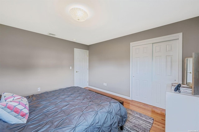 bedroom featuring hardwood / wood-style floors and a closet