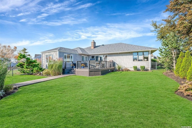 back of house with a lawn and a deck