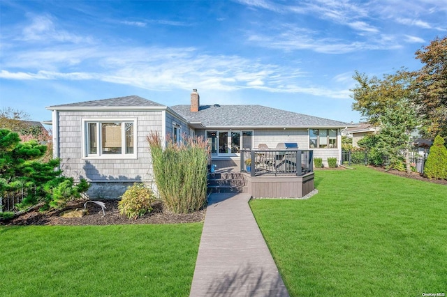 back of property with a lawn and a wooden deck