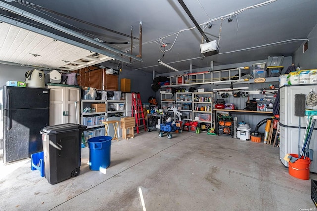 garage with black refrigerator and a garage door opener