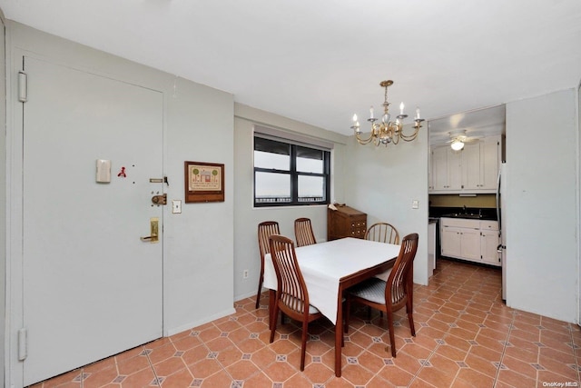 dining space featuring ceiling fan with notable chandelier and sink