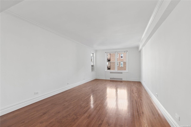 unfurnished room featuring wood-type flooring and crown molding