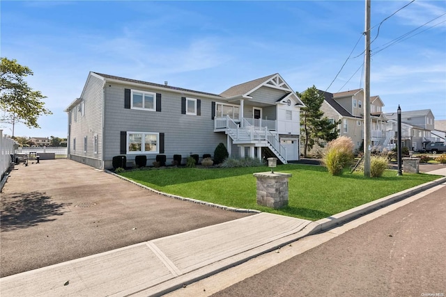 view of front of home featuring covered porch and a front yard