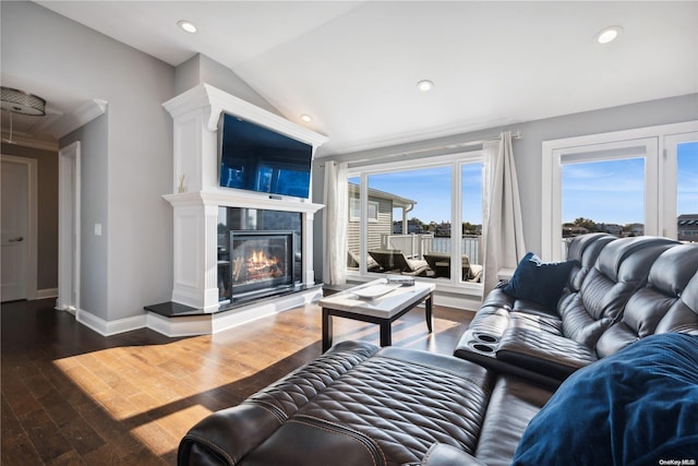 living room with ornamental molding, vaulted ceiling, and hardwood / wood-style flooring