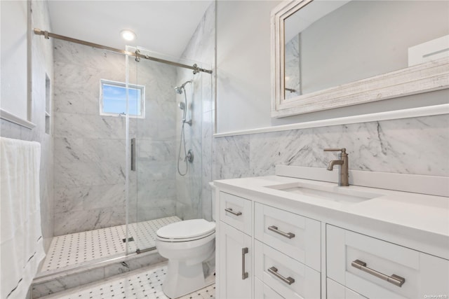 bathroom featuring vanity, toilet, an enclosed shower, and tile walls