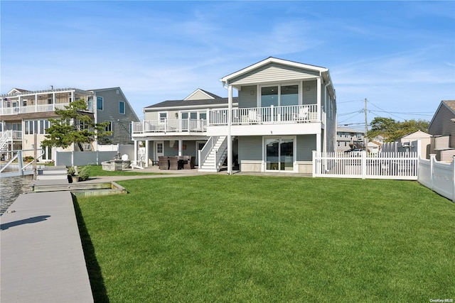 rear view of property with a patio and a lawn