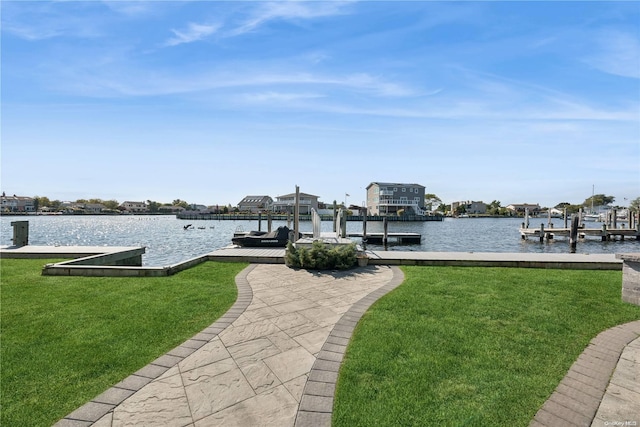 view of dock featuring a yard and a water view