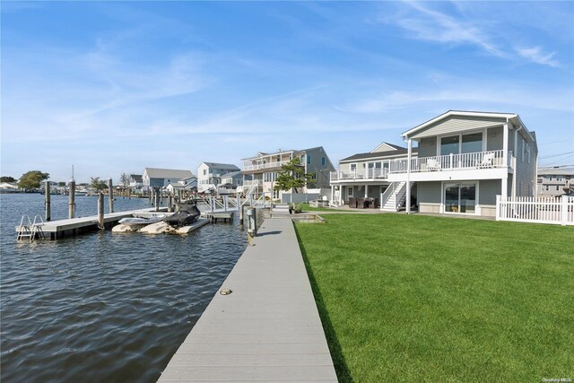 dock area with a yard and a water view