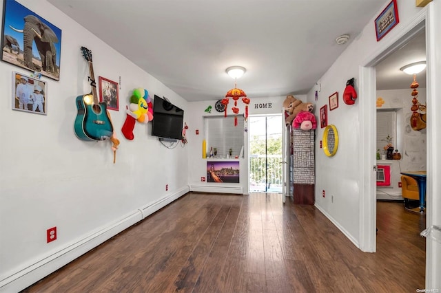 interior space featuring baseboard heating and dark wood-type flooring