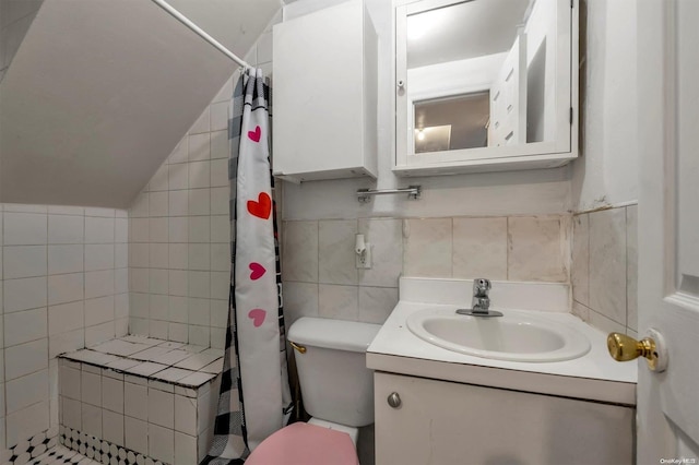 bathroom featuring vanity, toilet, tile walls, and walk in shower