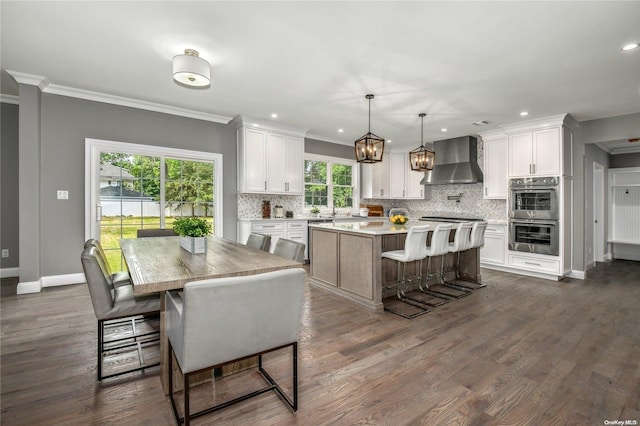 dining room featuring ornamental molding and dark wood-type flooring