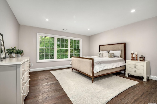 bedroom with dark hardwood / wood-style floors