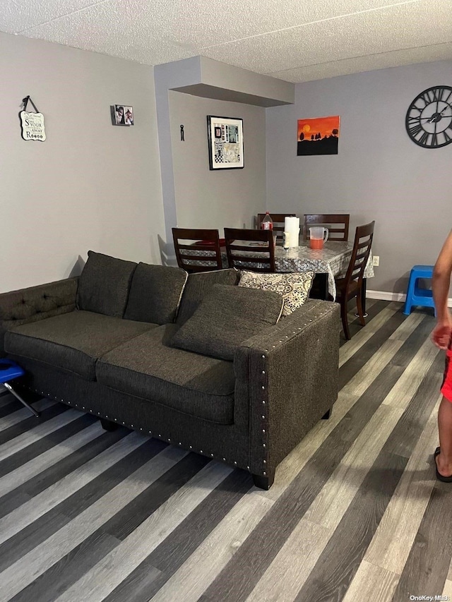 living room featuring wood-type flooring and a textured ceiling