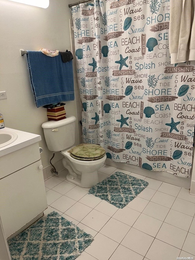 bathroom with tile patterned floors, vanity, and toilet