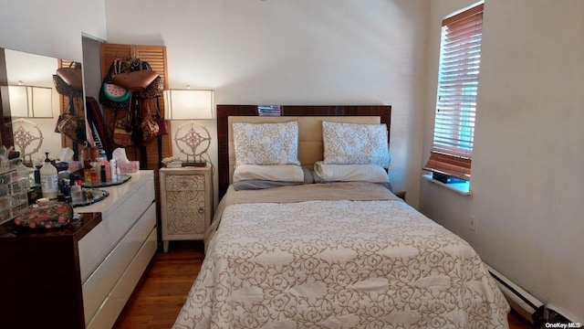 bedroom with dark hardwood / wood-style flooring