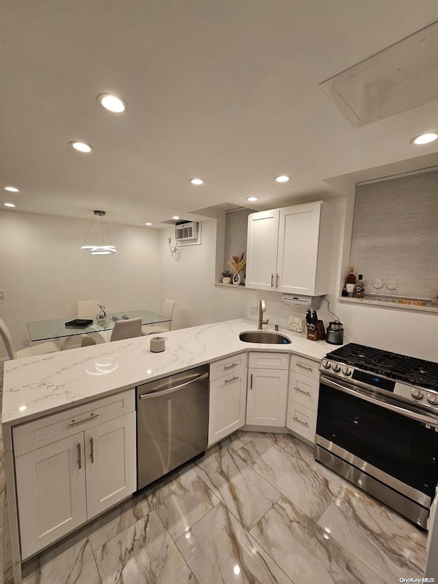 kitchen with sink, kitchen peninsula, hanging light fixtures, white cabinetry, and stainless steel appliances