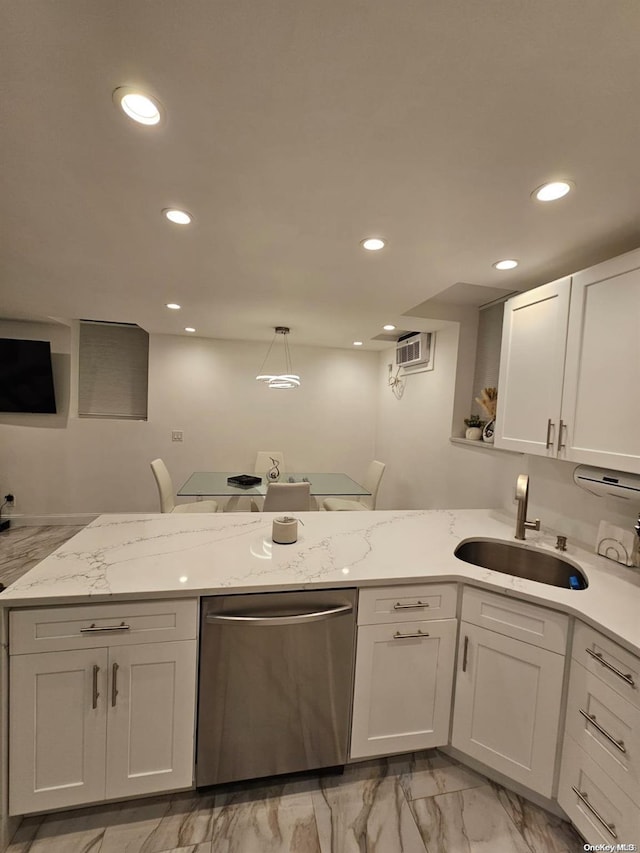 kitchen featuring light stone countertops, white cabinetry, sink, stainless steel dishwasher, and pendant lighting