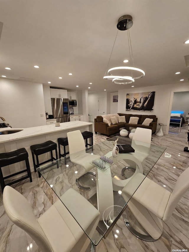 dining area featuring sink and a notable chandelier