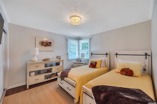 bedroom featuring wood-type flooring and ornamental molding