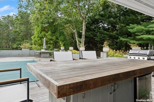 wooden deck with a covered pool