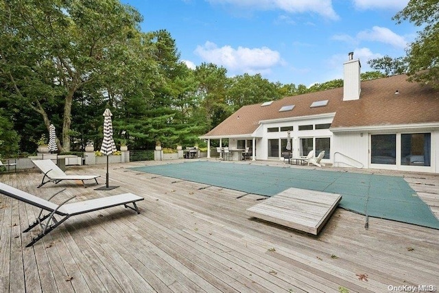 view of swimming pool with a wooden deck