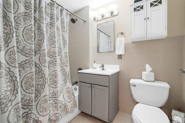 full bathroom featuring shower / bath combination with curtain, tile patterned floors, and tile walls