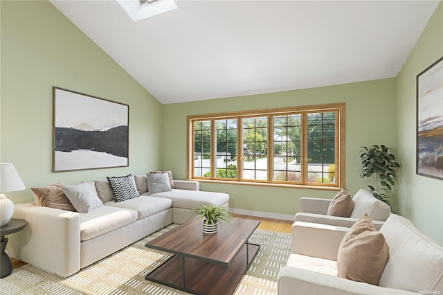 living room featuring light wood-type flooring and vaulted ceiling with skylight