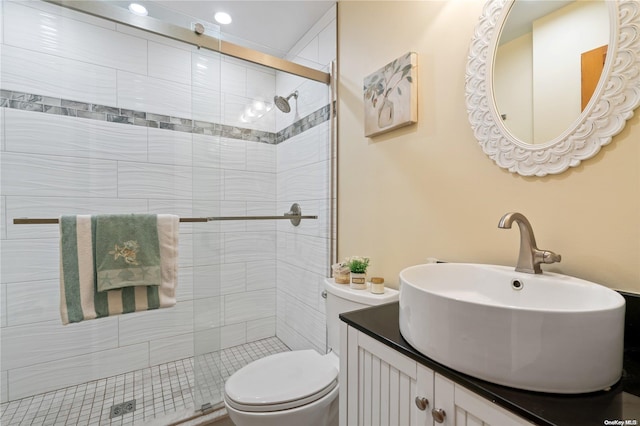 bathroom featuring vanity, toilet, and walk in shower