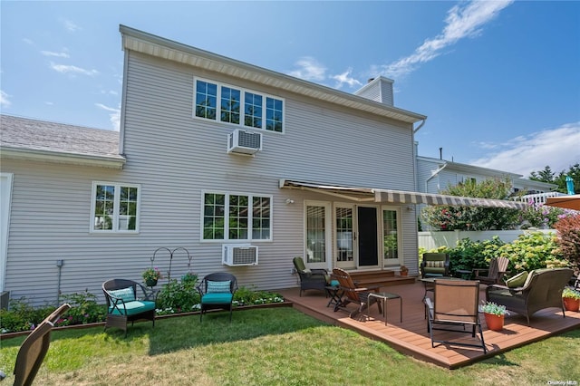 back of property featuring a deck and a lawn