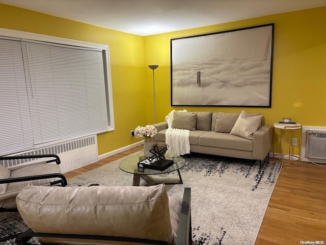 living room featuring wood-type flooring and radiator heating unit