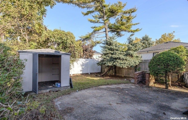 view of patio with a storage shed