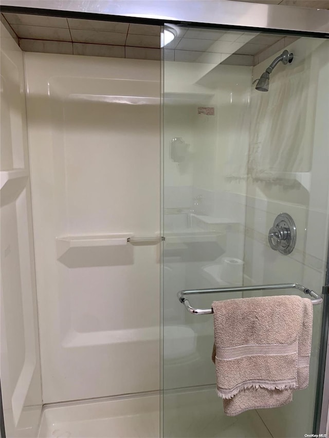 bathroom with a shower with shower door