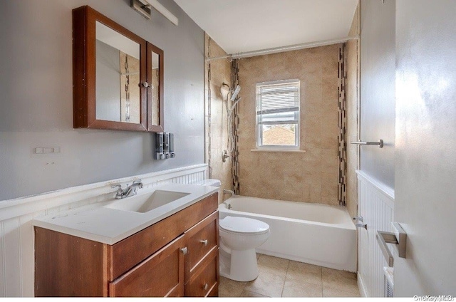 full bathroom featuring tile patterned floors, vanity, tiled shower / bath combo, and toilet