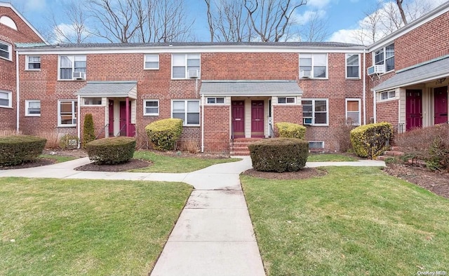 view of property featuring a front lawn