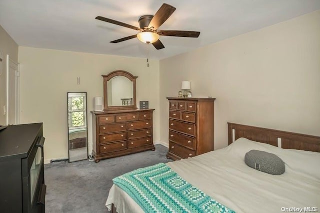 bedroom featuring dark carpet and ceiling fan