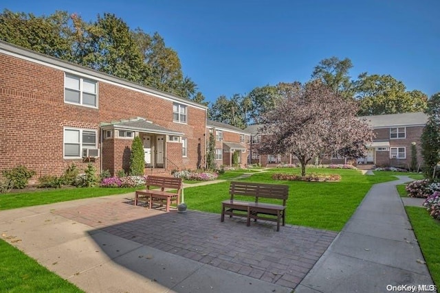 view of community featuring a yard and a patio