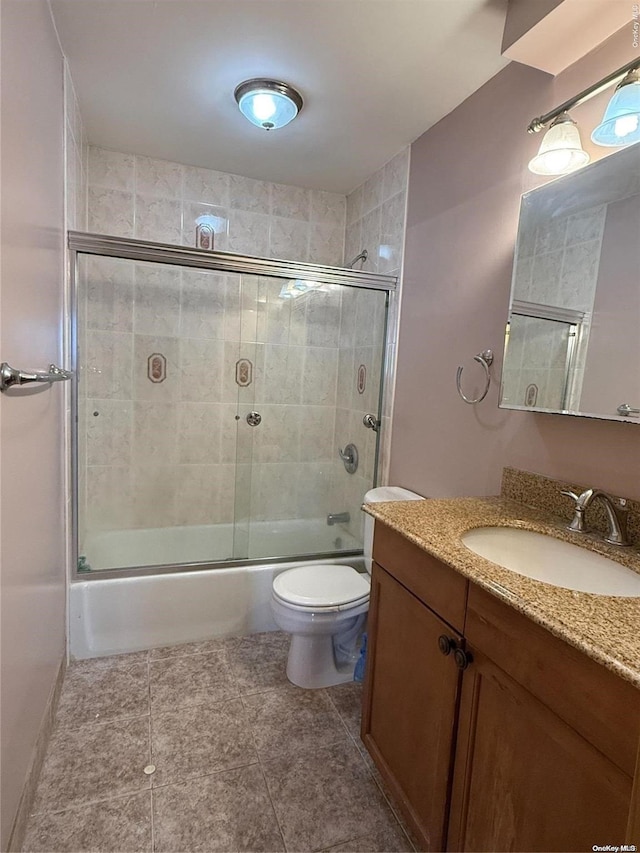 full bathroom with tile patterned floors, vanity, toilet, and enclosed tub / shower combo