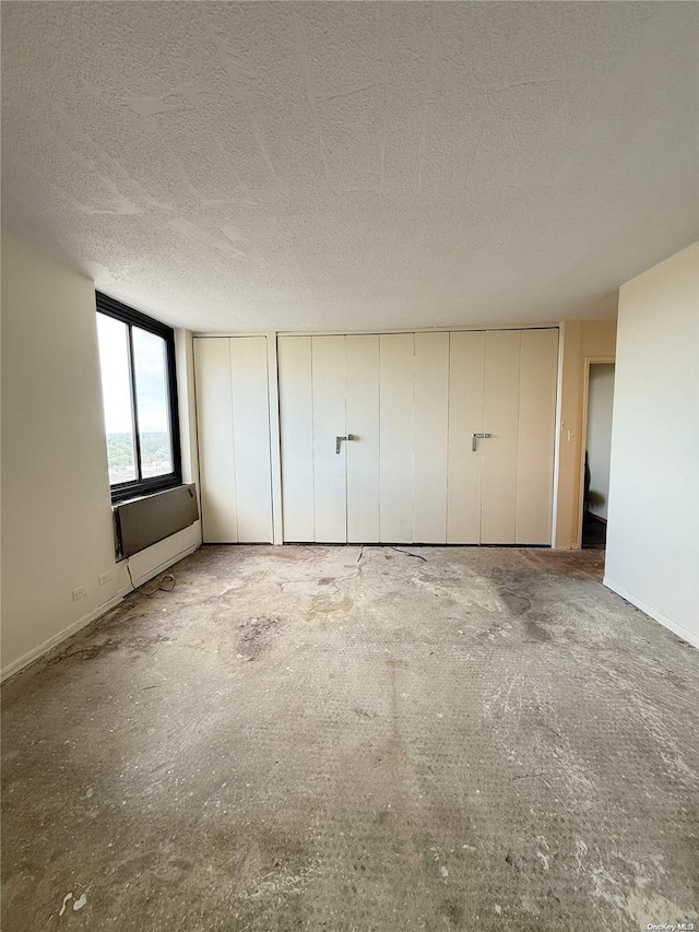 unfurnished bedroom with a textured ceiling