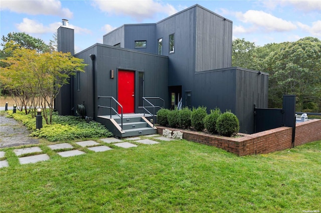 707 Pleasure Dr, Flanders, NY 11901 - contemporary house with a front lawn and a chimney