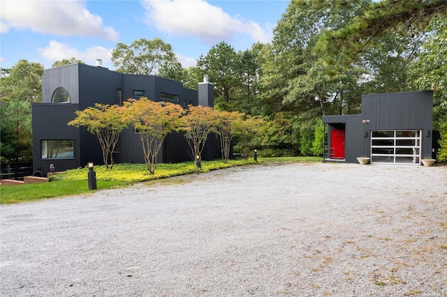 707 Pleasure Dr, Flanders, NY 11901 - view of front of house with a garage and an outdoor structure