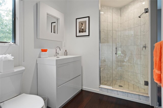 707 Pleasure Dr, Flanders, NY 11901 - full bath featuring toilet, wood finished floors, vanity, a stall shower, and baseboards
