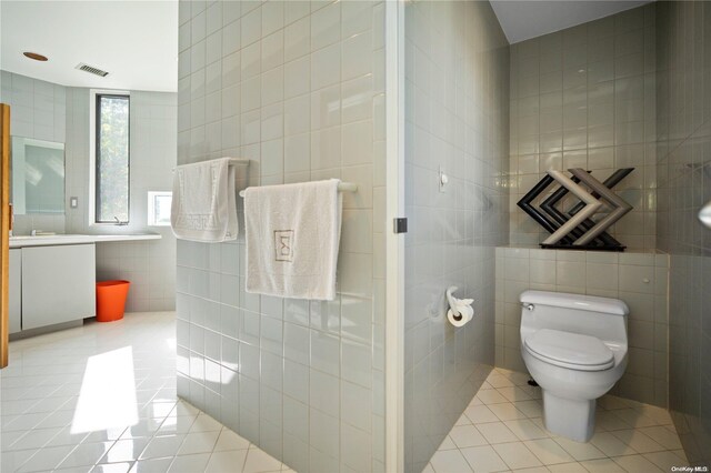 707 Pleasure Dr, Flanders, NY 11901 - full bath featuring tile walls, tile patterned flooring, vanity, and toilet