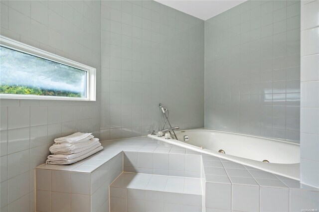 707 Pleasure Dr, Flanders, NY 11901 - bathroom featuring a tub with jets and tile walls